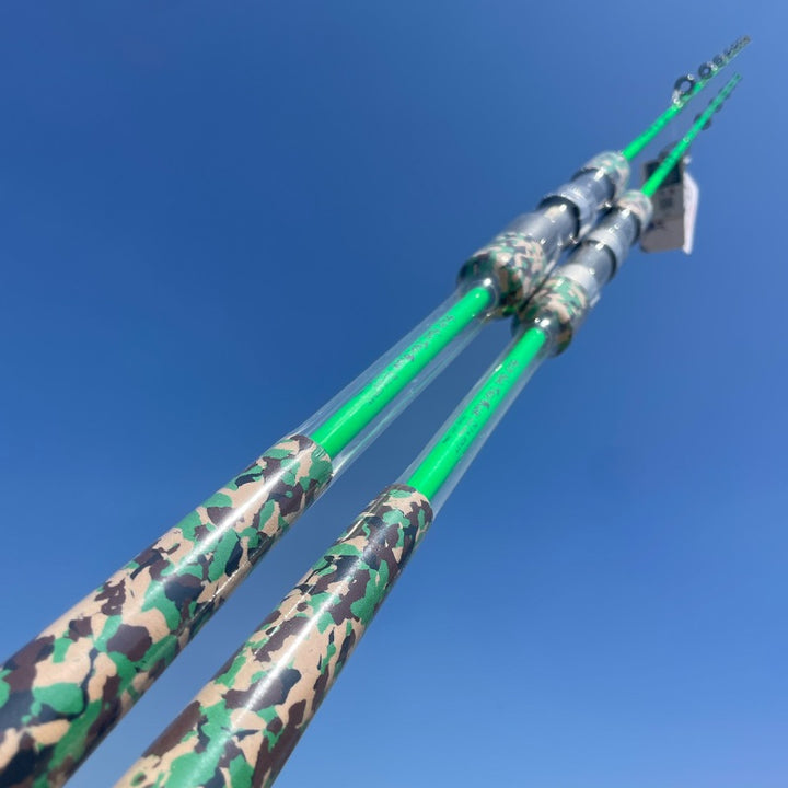 Two green GOOFISH Ares rods with camouflage grips and reel seats shown against a blue sky